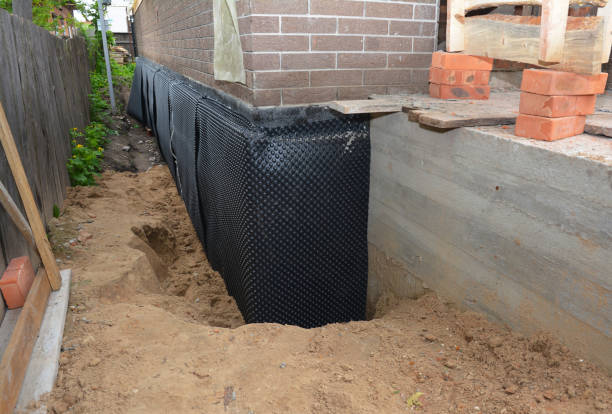 SJ Waterproofing Pros technician performing targeted Wet Basement Repair assessment in Auburn, KS